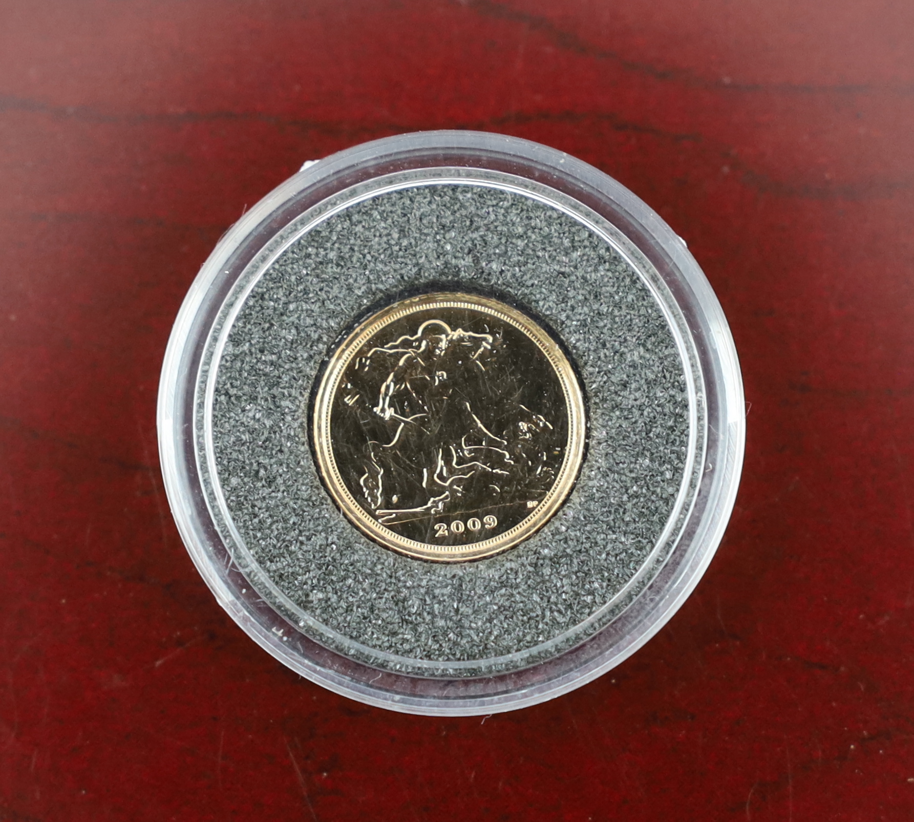 British Gold Coins, QEII 2000 1/4 sovereign of Britain and a 2008 25th anniversary 1/20th ounce gold angel coin, complete with certificates in a leather binder and a London mint office penny black 170th anniversary stamp